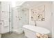Elegant bathroom featuring a soaking tub and a glass-enclosed shower with beautiful marble-like finishes at 4547 Tally Ho Trl, Boulder, CO 80301