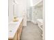 Bright bathroom showcasing a soaking tub and glass-enclosed shower with marble tile and neutral colored tiling at 4547 Tally Ho Trl, Boulder, CO 80301