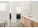 Bathroom featuring double sinks, a vanity with light wood cabinets, and a glimpse into the closet at 4547 Tally Ho Trl, Boulder, CO 80301
