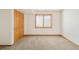 Bright bedroom featuring carpeted floor, a window, and a closet with light wooden doors at 4547 Tally Ho Trl, Boulder, CO 80301