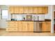 Functional kitchen with light wood cabinets, stainless steel appliances, and black countertops for efficient meal prep at 4547 Tally Ho Trl, Boulder, CO 80301