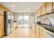 Bright kitchen with light wood cabinets, stainless steel refrigerator, and sliding door access to an outdoor deck at 4547 Tally Ho Trl, Boulder, CO 80301
