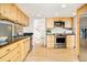 Modern kitchen featuring light wood cabinets, stainless steel appliances, and sleek black countertops at 4547 Tally Ho Trl, Boulder, CO 80301