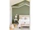 Serene bedroom with green accent wall, hardwood floors, and cozy decor at 4547 Tally Ho Trl, Boulder, CO 80301