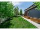 Expansive backyard featuring a well-manicured lawn, privacy fence, and lovely landscaping at 900 Wilshire Dr, Berthoud, CO 80513