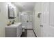 A renovated bathroom with a sleek vanity, modern fixtures, and a glass-enclosed shower at 900 Wilshire Dr, Berthoud, CO 80513