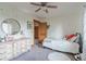 Cozy bedroom featuring a charming dresser, ceiling fan, and twin bed at 900 Wilshire Dr, Berthoud, CO 80513