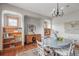 Inviting dining room featuring hardwood floors, built-in shelving, and a charming round table with seating for four at 900 Wilshire Dr, Berthoud, CO 80513