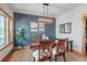 Stylish dining room with a wooden table, decorative lighting, and a feature wall at 900 Wilshire Dr, Berthoud, CO 80513