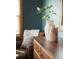 Decorated dresser with an armchair in the background, illuminated by natural light at 900 Wilshire Dr, Berthoud, CO 80513