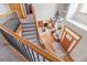 Bright foyer and living room, featuring wood floors, a staircase, and large chandelier at 900 Wilshire Dr, Berthoud, CO 80513