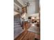 Beautiful foyer featuring a curved staircase, hardwood floors, and views into the living room at 900 Wilshire Dr, Berthoud, CO 80513