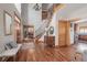 Stunning foyer with high ceilings, hardwood floors, elegant staircase, and a decorative chandelier at 900 Wilshire Dr, Berthoud, CO 80513