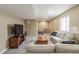 A finished basement living room featuring comfortable sofas, a TV, and an adjacent study area at 900 Wilshire Dr, Berthoud, CO 80513