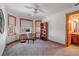 Office space with built-in shelving, large windows, and access to a bathroom at 900 Wilshire Dr, Berthoud, CO 80513