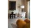 Cozy sitting area featuring a comfortable armchair, accent table, and natural light at 900 Wilshire Dr, Berthoud, CO 80513