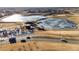 An aerial view of a community park with frozen ponds, a playground, and food trucks on a clear, sunny day at 11423 Steele St, Thornton, CO 80233