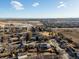 An aerial view showcasing the neighborhood with community parks and local businesses on a clear, sunny day at 11423 Steele St, Thornton, CO 80233