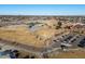 An aerial view of a community park with parking, picnic tables, tennis courts, and trails on a clear, sunny day at 11423 Steele St, Thornton, CO 80233