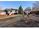 Grassy backyard with a covered shed and a wooden fence at 11423 Steele St, Thornton, CO 80233