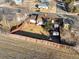 An aerial view of a home with a fenced backyard, firepit, and small storage sheds on a clear, sunny day at 11423 Steele St, Thornton, CO 80233