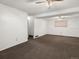 Open basement area featuring neutral carpet, paneled walls, and two ceiling fans at 11423 Steele St, Thornton, CO 80233