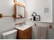 Cozy bathroom featuring a wooden vanity, sink, and medicine cabinet at 11423 Steele St, Thornton, CO 80233