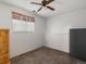 Bedroom features a ceiling fan, a large window, and neutral carpet at 11423 Steele St, Thornton, CO 80233