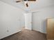 Bright bedroom features a ceiling fan, white closets and neutral carpet at 11423 Steele St, Thornton, CO 80233