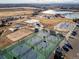 An aerial view of a community park with tennis courts, beach volleyball, and more on a clear, sunny day at 11423 Steele St, Thornton, CO 80233