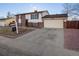 Exterior elevation of a well-maintained house with an attached garage and a manicured front yard at 11423 Steele St, Thornton, CO 80233