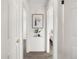 This hallway features carpeted floors, neutral paint, and natural lighting at 11423 Steele St, Thornton, CO 80233