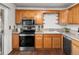 Functional kitchen featuring stainless steel appliances, wooden cabinets, and ample counter space at 11423 Steele St, Thornton, CO 80233