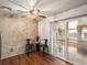 This living room features stone-look walls, vinyl floors, and natural lighting at 11423 Steele St, Thornton, CO 80233