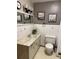 Clean bathroom with a toilet, sink, and vanity at 3515 Pierce St, Wheat Ridge, CO 80033