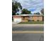 Brick ranch home with attached garage, well-manicured lawn, and chain link fence at 3515 Pierce St, Wheat Ridge, CO 80033