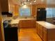 Bright kitchen with wood cabinets, an island, and black appliances at 3515 Pierce St, Wheat Ridge, CO 80033