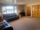 Living room with leather sofas, piano, and entryway view at 3515 Pierce St, Wheat Ridge, CO 80033