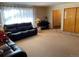 Living room with leather sofas, piano, and entryway view at 3515 Pierce St, Wheat Ridge, CO 80033