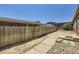 Backyard with wood fence, rocks, landscaping, and access to the house at 253 Cherokee Pl, Brighton, CO 80603
