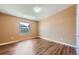 This well lit empty room offers gorgeous hardwood floors and a window to let in natural light at 253 Cherokee Pl, Brighton, CO 80603