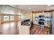 Open floor plan featuring a kitchen with stainless steel appliances and hardwood floors at 253 Cherokee Pl, Brighton, CO 80603
