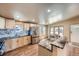 Bright kitchen with stainless steel appliances and black marble countertops and floors at 253 Cherokee Pl, Brighton, CO 80603