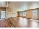 Comfortable living room with hardwood floors and large windows for ample sunlight at 253 Cherokee Pl, Brighton, CO 80603