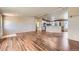 Open-concept living room with hardwood floors flowing into the kitchen, great for entertaining at 253 Cherokee Pl, Brighton, CO 80603