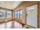 Inviting sunroom with hardwood floors and windows offering neighborhood views at 253 Cherokee Pl, Brighton, CO 80603
