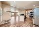 Open floor plan boasts updated kitchen with stainless steel appliances and gorgeous hardwood floors at 253 Cherokee Pl, Brighton, CO 80603