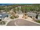 Aerial shot of a grey home with a three-car garage, manicured landscaping, and mountain views at 1798 Summerglow Ln, Monument, CO 80132