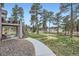 Expansive backyard with mature trees, split rail fence, stone walkway and access to a deck at 1798 Summerglow Ln, Monument, CO 80132