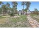 Expansive backyard with mature trees, split rail fence, and landscaped areas at 1798 Summerglow Ln, Monument, CO 80132
